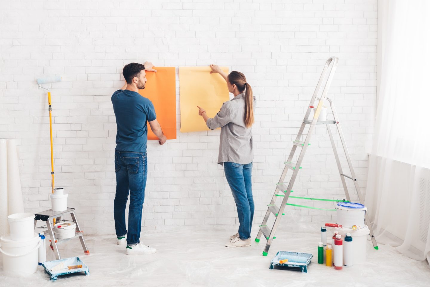 young-happy-couple-choosing-in-what-color-painting-their-new-house-e1623048178300
